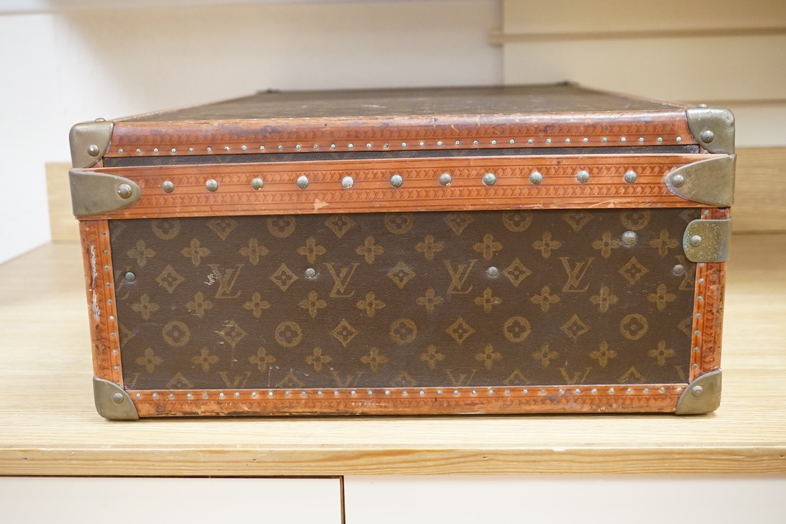A vintage Louis Vuitton monogram suitcase with two original keys, numbered 793692 to the linen covered interior, height 22cm, width 76cm, depth 46cm